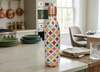 Colorful patterned water bottle on a kitchen counter with copper accents
